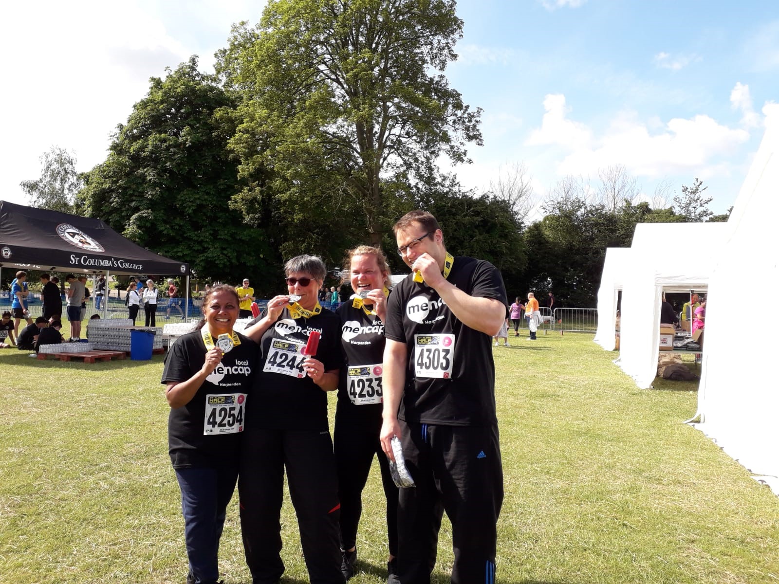 Group of four people showing medals | Harpenden Mencap