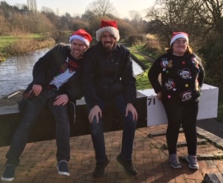 Staff and tenants wearing Santa hats and smiling | Harpenden Mencap