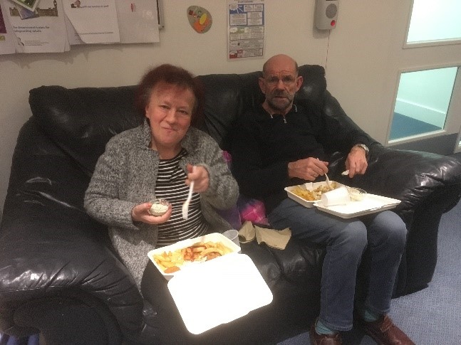 A man and a woman eating a takeaway | Harpenden Mencap