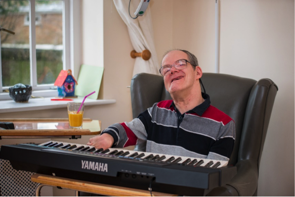 Resident playing the piano | Harpenden Mencap