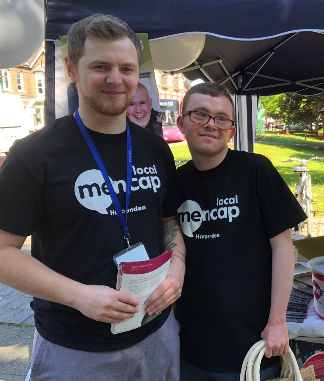 Two men smiling holding leaflets | Harpenden Mencap