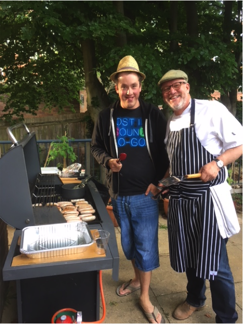 Two gentleman cooking food on a BBQ | Harpenden Mencap