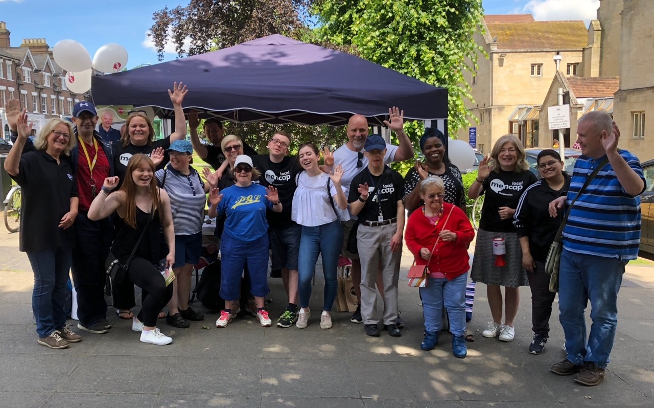 Group of people waving and smiling | Harpenden Mencap